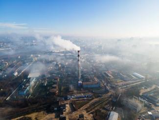 Photo aérienne d'un ensemble d'usines. Des cheminées d'usine fument.